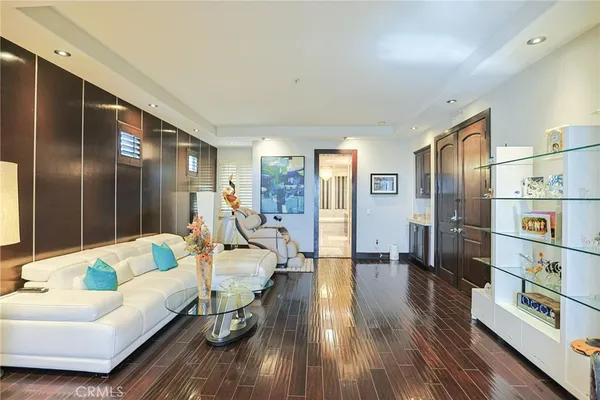 a bedroom with a large bed and a wooden floor