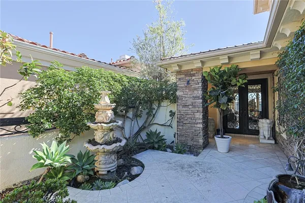 a front view of a house with a potted plant