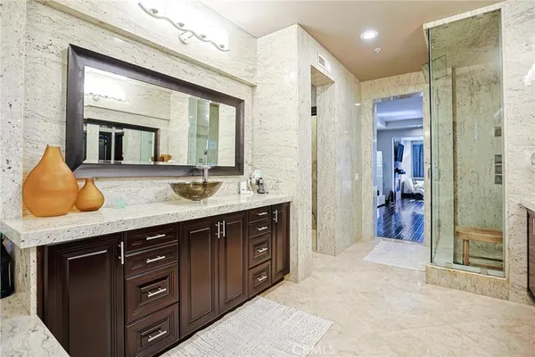 a spacious bathroom with a granite countertop sink and a mirror