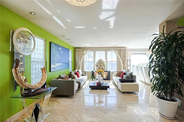 a living room with fireplace furniture and a large window