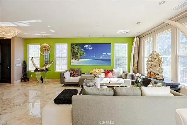 a living room with furniture and a potted plant