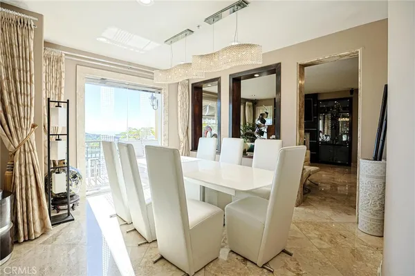 a kitchen with stainless steel appliances kitchen island granite countertop a refrigerator a stove and a sink with wooden floor