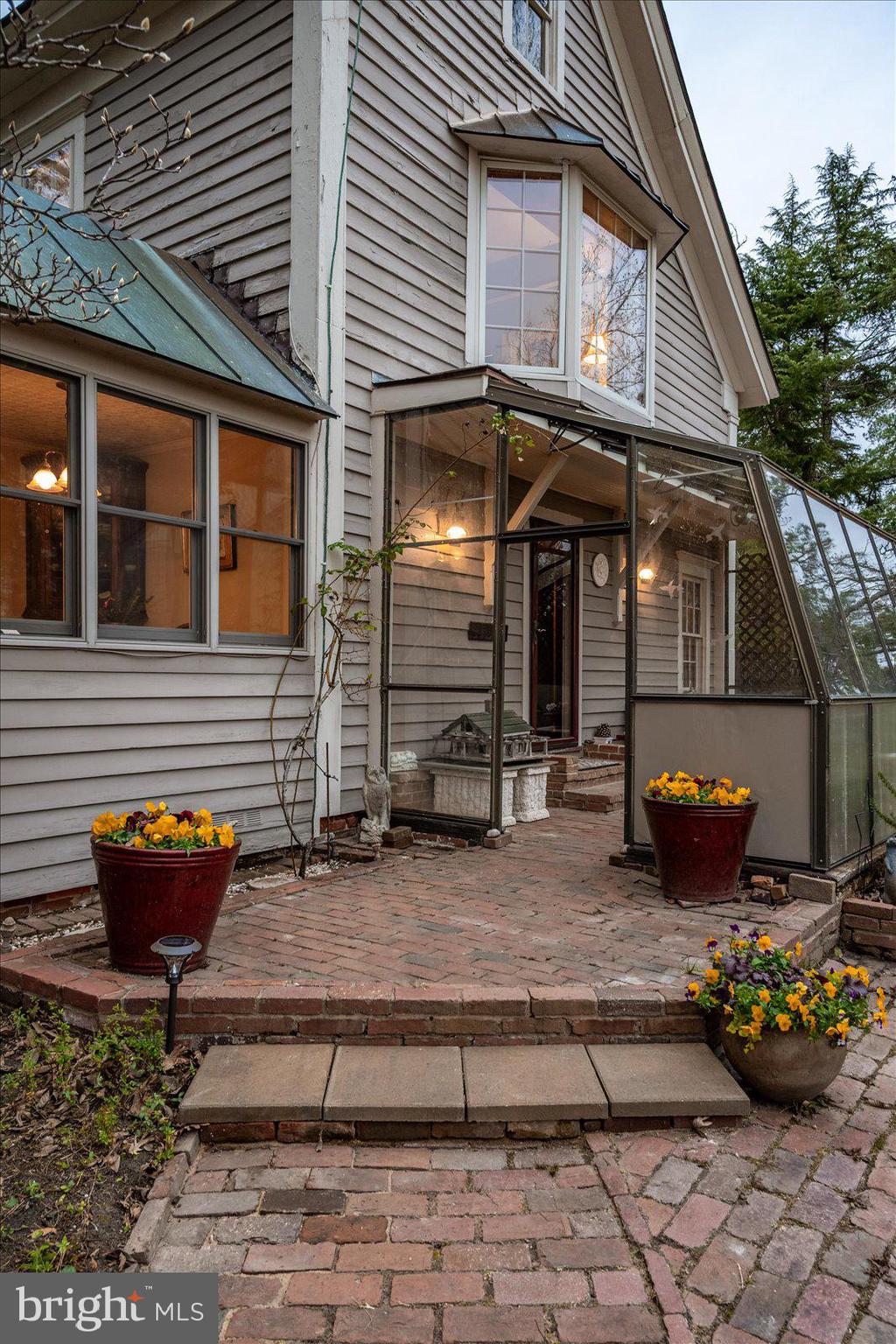 27947 Fairmount Road Westover, MD 21871 - Photo 30 of 122 a view of a house with patio chairs and a potted plant