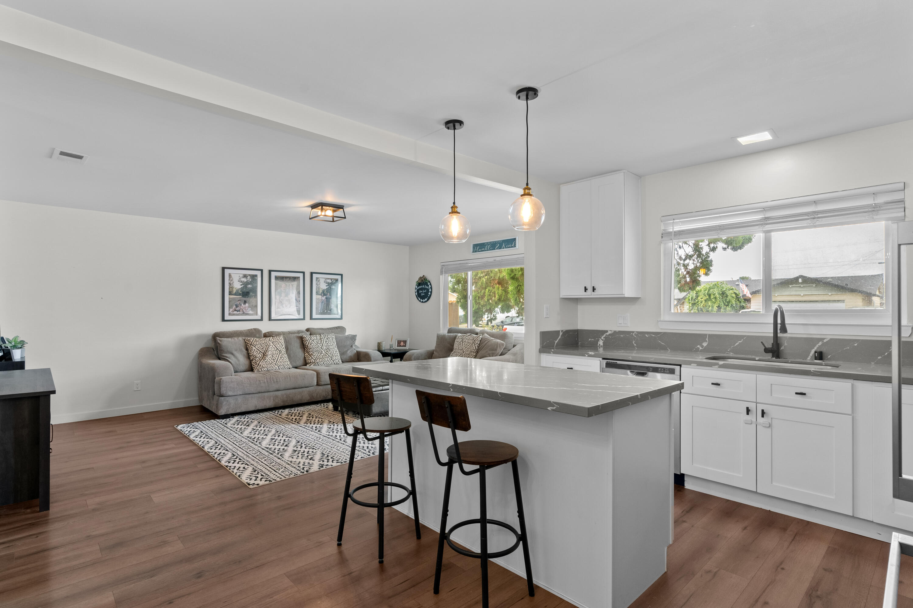 1220 West Lime Avenue Lompoc, CA 93436 - Photo 11 of 48 a kitchen with a sink stove and wooden floor
