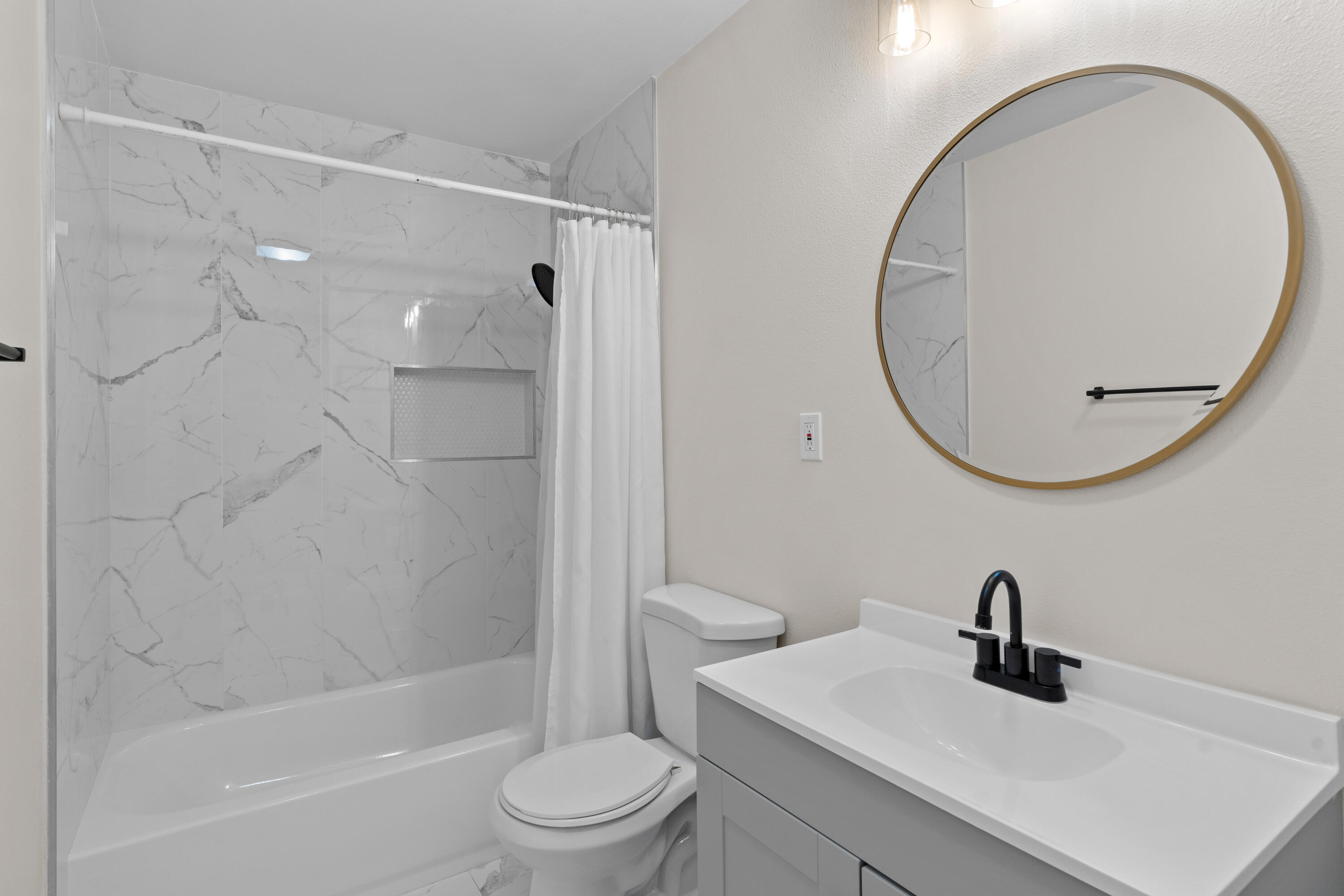 1220 West Lime Avenue Lompoc, CA 93436 - Photo 19 of 48 a bathroom with a sink a toilet and a mirror