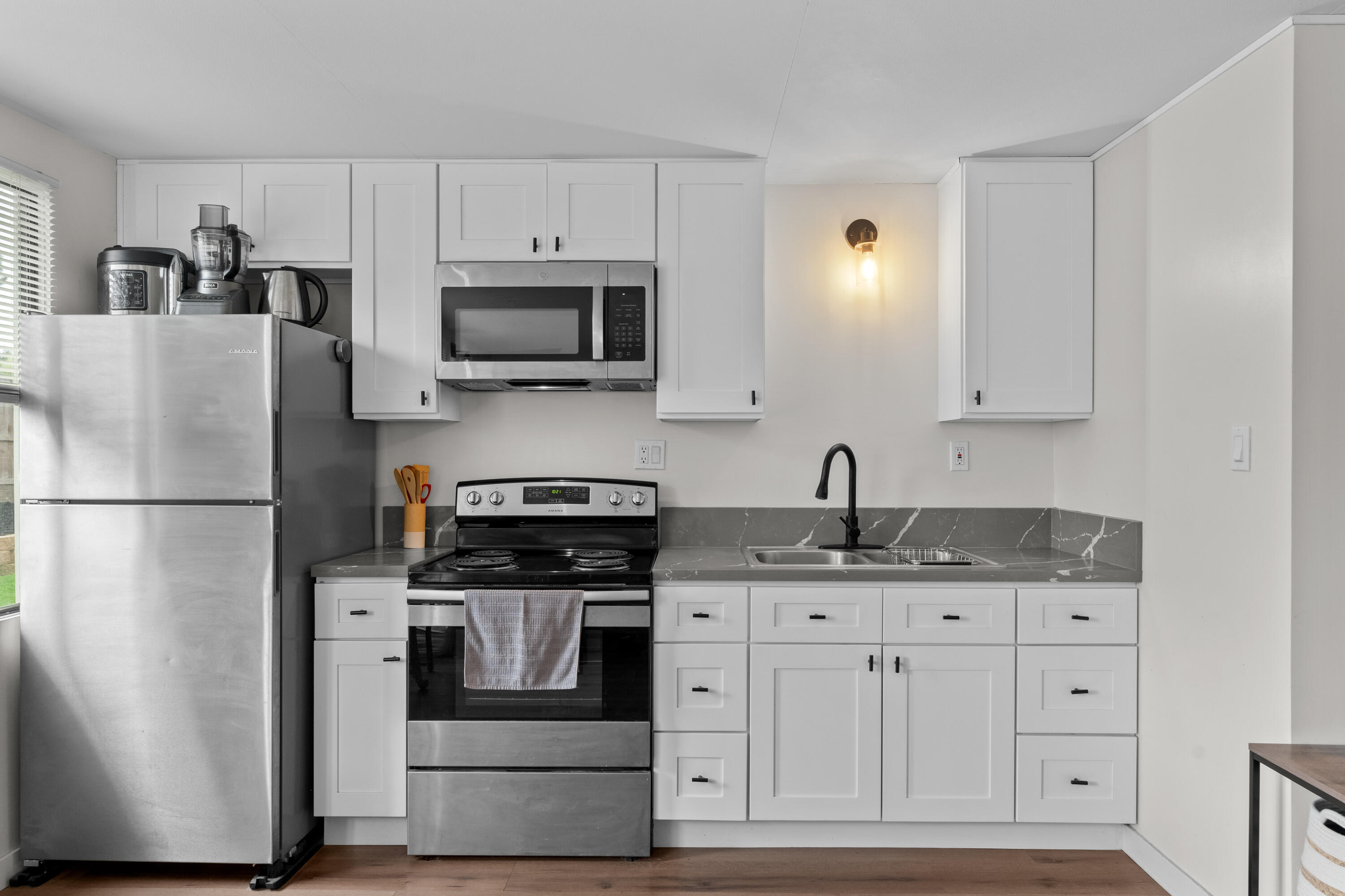 1220 West Lime Avenue Lompoc, CA 93436 - Photo 26 of 48 a kitchen with appliances a sink and cabinets