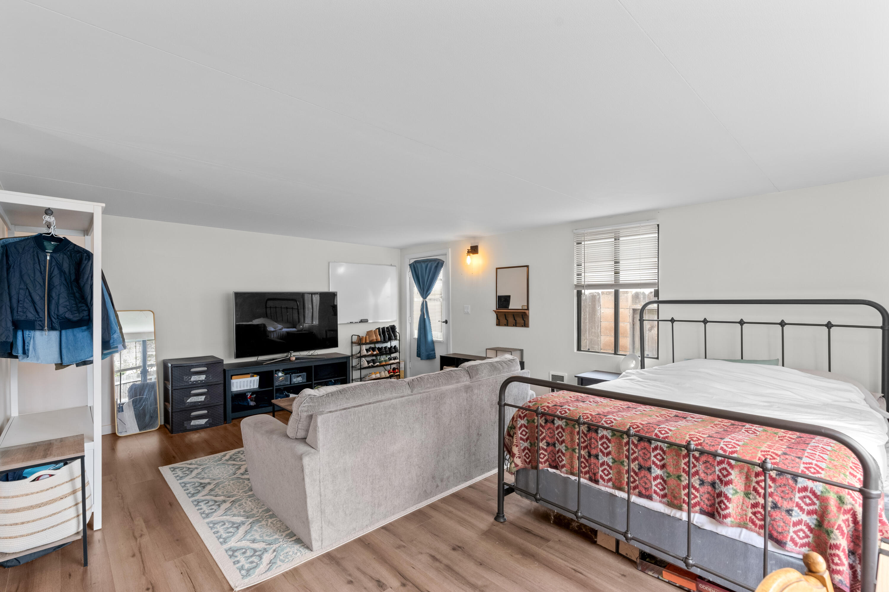 1220 West Lime Avenue Lompoc, CA 93436 - Photo 29 of 48 a large bedroom with a bed and wooden floor