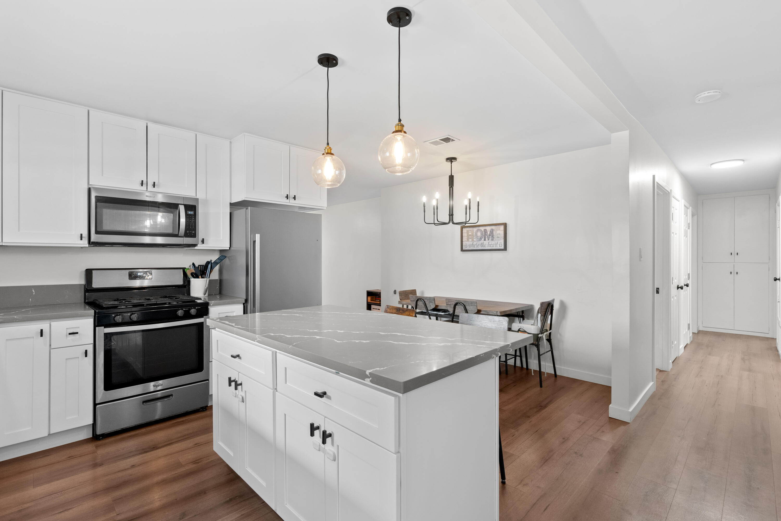 1220 West Lime Avenue Lompoc, CA 93436 - Photo 9 of 48 a kitchen with a stove a sink and a refrigerator