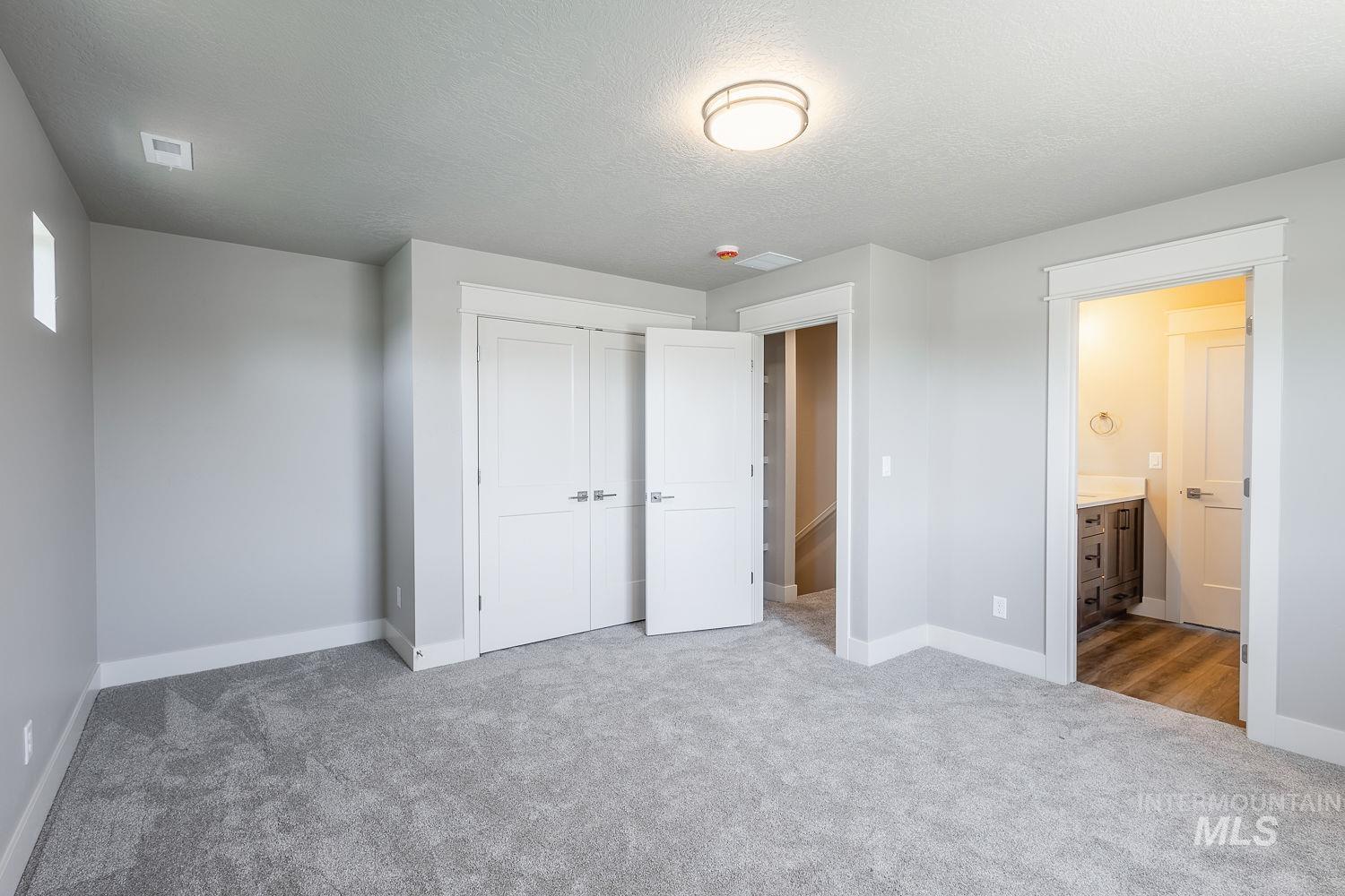 1171 West Recess Way Kuna, ID 83634 - Photo 20 of 28 Carpeted room featuring light gray wall paint and white trim