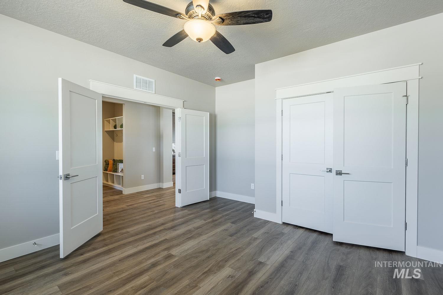 1171 West Recess Way Kuna, ID 83634 - Photo 23 of 28 Interior room featuring wood-finish flooring, a ceiling fan with integrated lighting, and neutral wall tones
