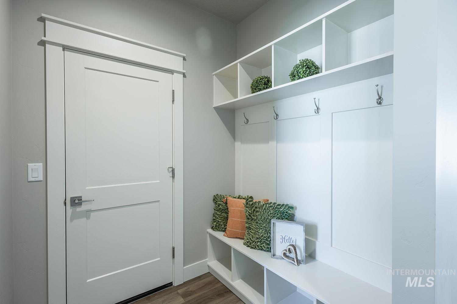 1171 West Recess Way Kuna, ID 83634 - Photo 24 of 28 Custom built-in entryway storage featuring open shelving, integrated coat hooks, and bench seating with cubbies
