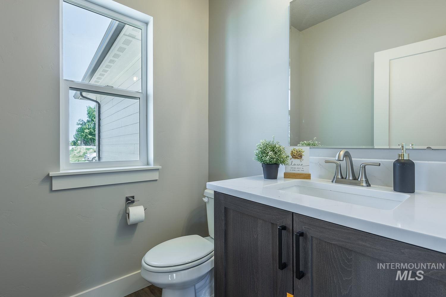 1171 West Recess Way Kuna, ID 83634 - Photo 25 of 28 Bathroom vanity with white countertop, integrated rectangular sink, and brushed nickel faucet