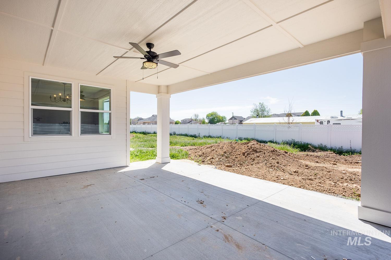 1171 West Recess Way Kuna, ID 83634 - Photo 26 of 28 Covered patio featuring a ceiling fan with integrated lighting, concrete flooring, and a white plank-style exterior wall