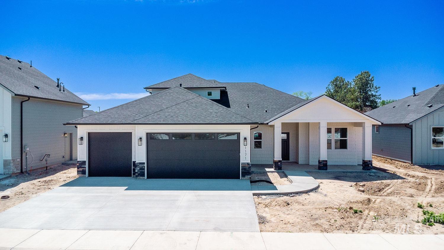 1171 West Recess Way Kuna, ID 83634 - Photo 27 of 28 Contemporary single-story residence featuring a dark gray shingle roof and light-colored siding