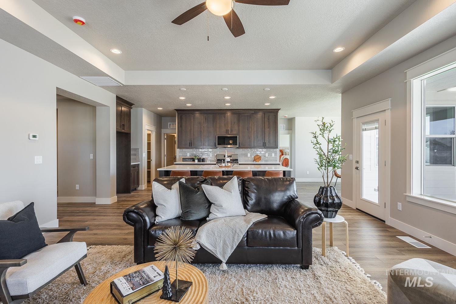 1171 West Recess Way Kuna, ID 83634 - Photo 3 of 28 Open-concept living space featuring wood-finish flooring, recessed lighting, and a ceiling fan