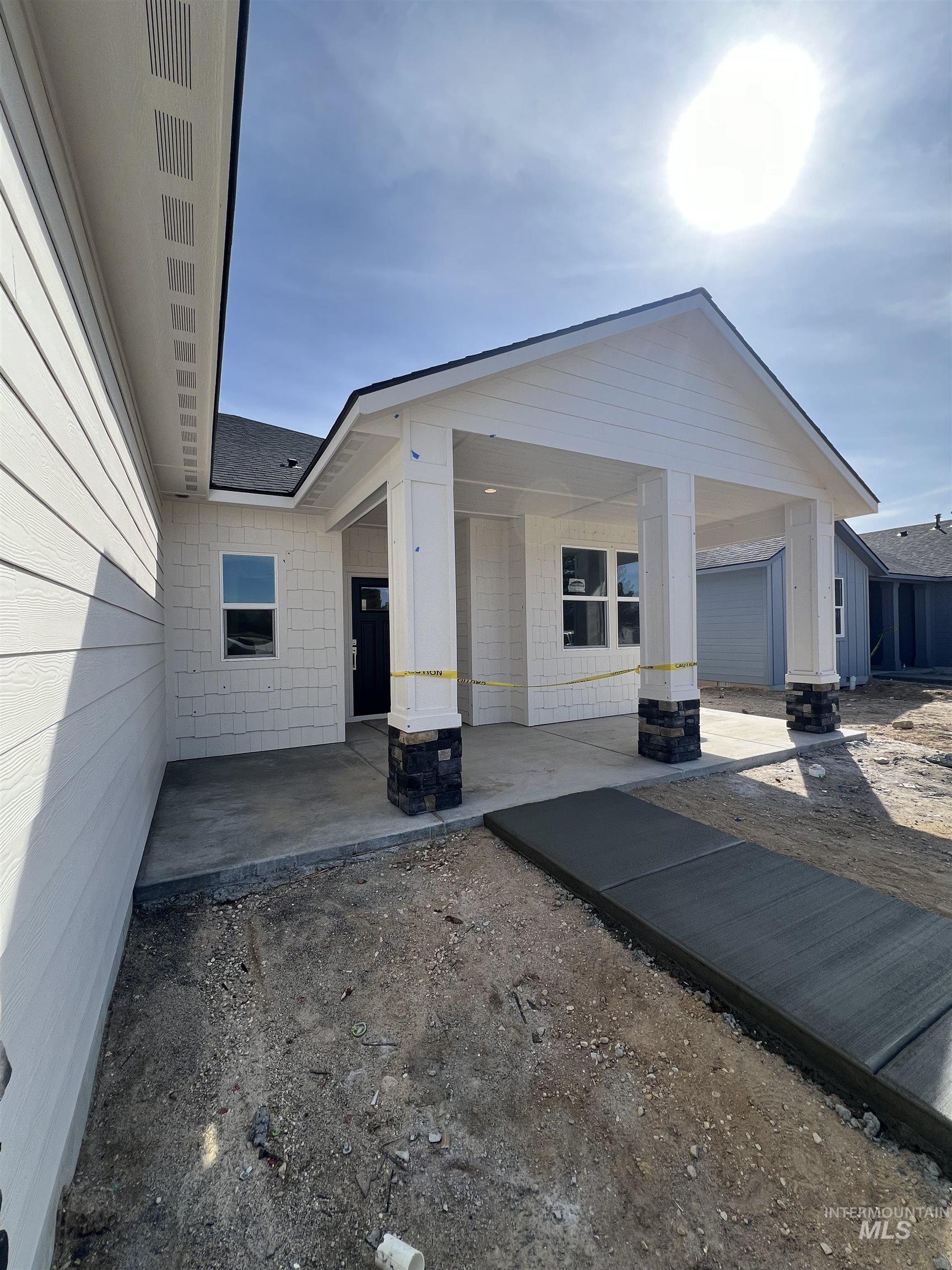 1171 West Recess Way Kuna, ID 83634 - Photo 3 of 15 View of front of home with a patio