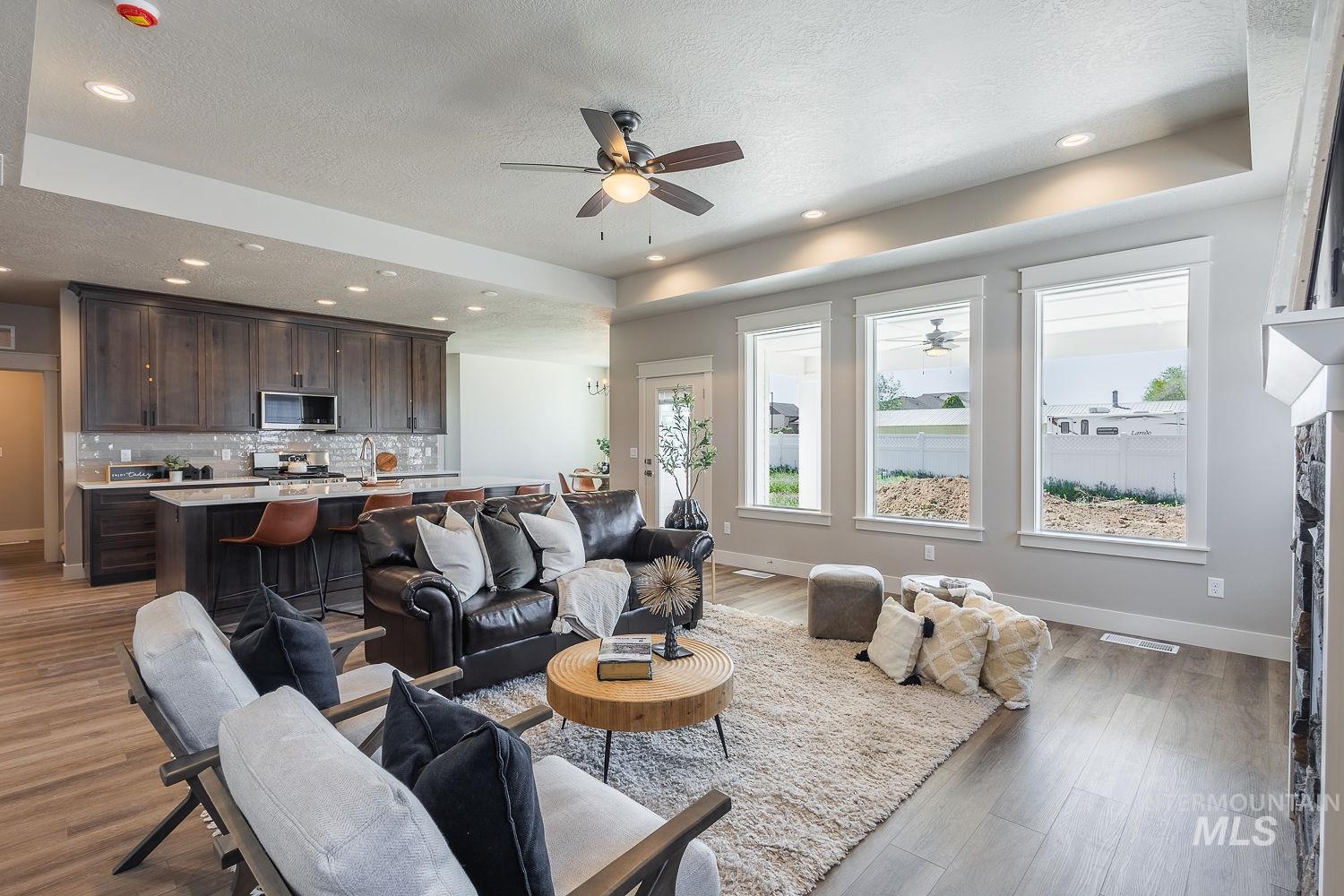 1171 West Recess Way Kuna, ID 83634 - Photo 5 of 28 Open-concept living space featuring wood-finish flooring, recessed lighting, and a ceiling fan