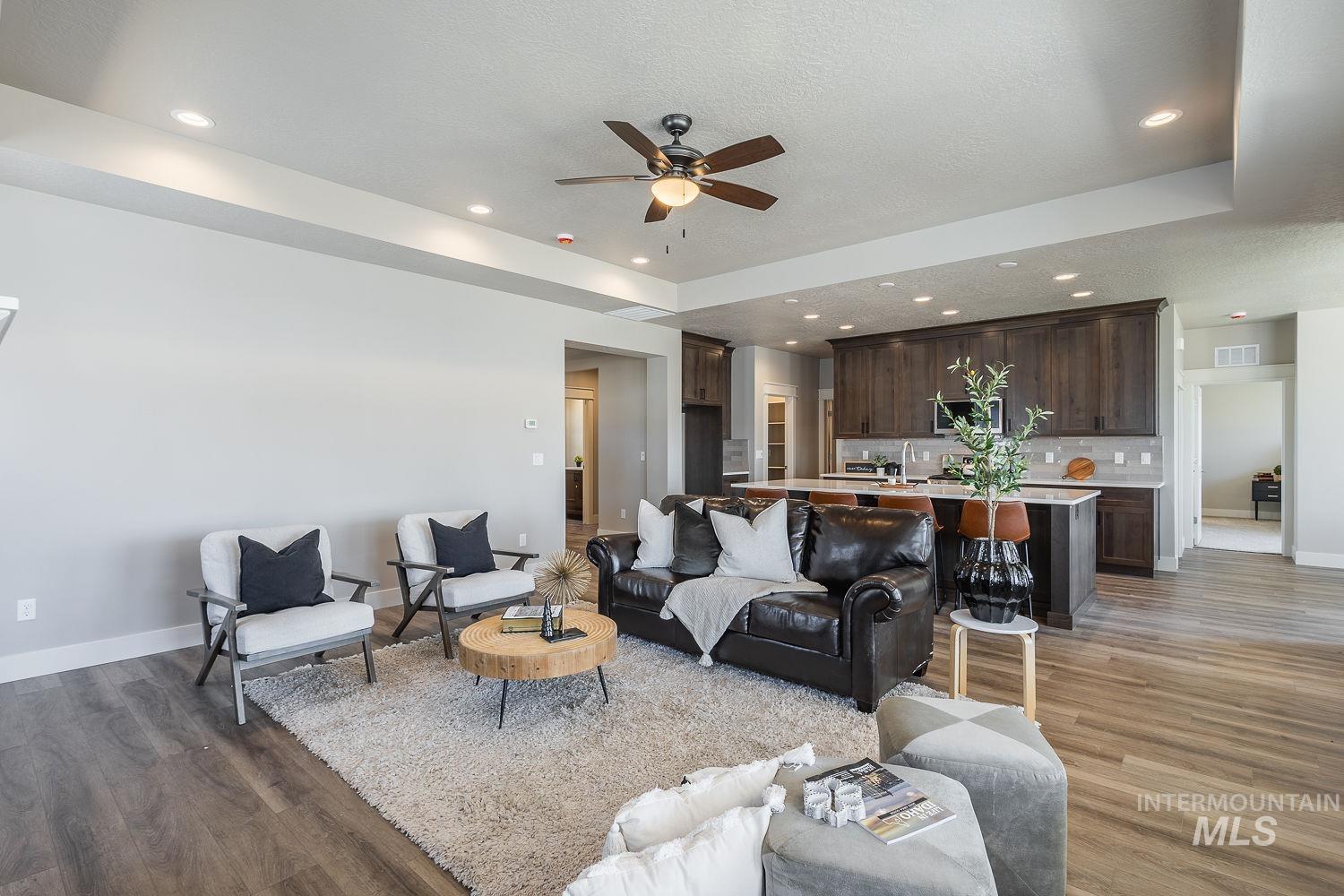 1171 West Recess Way Kuna, ID 83634 - Photo 6 of 28 Open-concept living space featuring wood-finish flooring, recessed lighting, and a ceiling fan