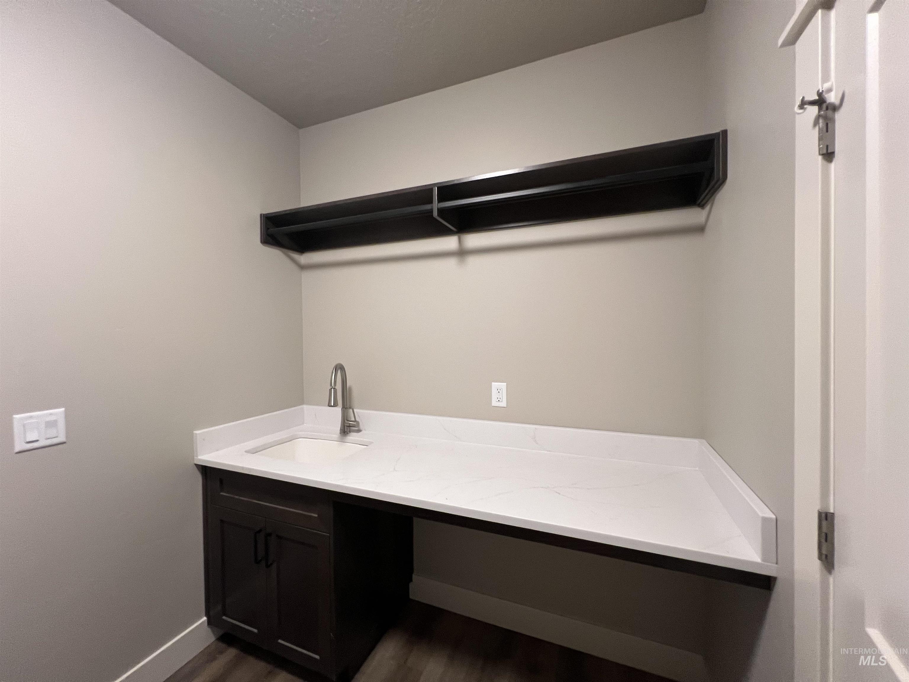 1171 West Recess Way Kuna, ID 83634 - Photo 10 of 15 Laundry room with dark wood-style floors and a sink