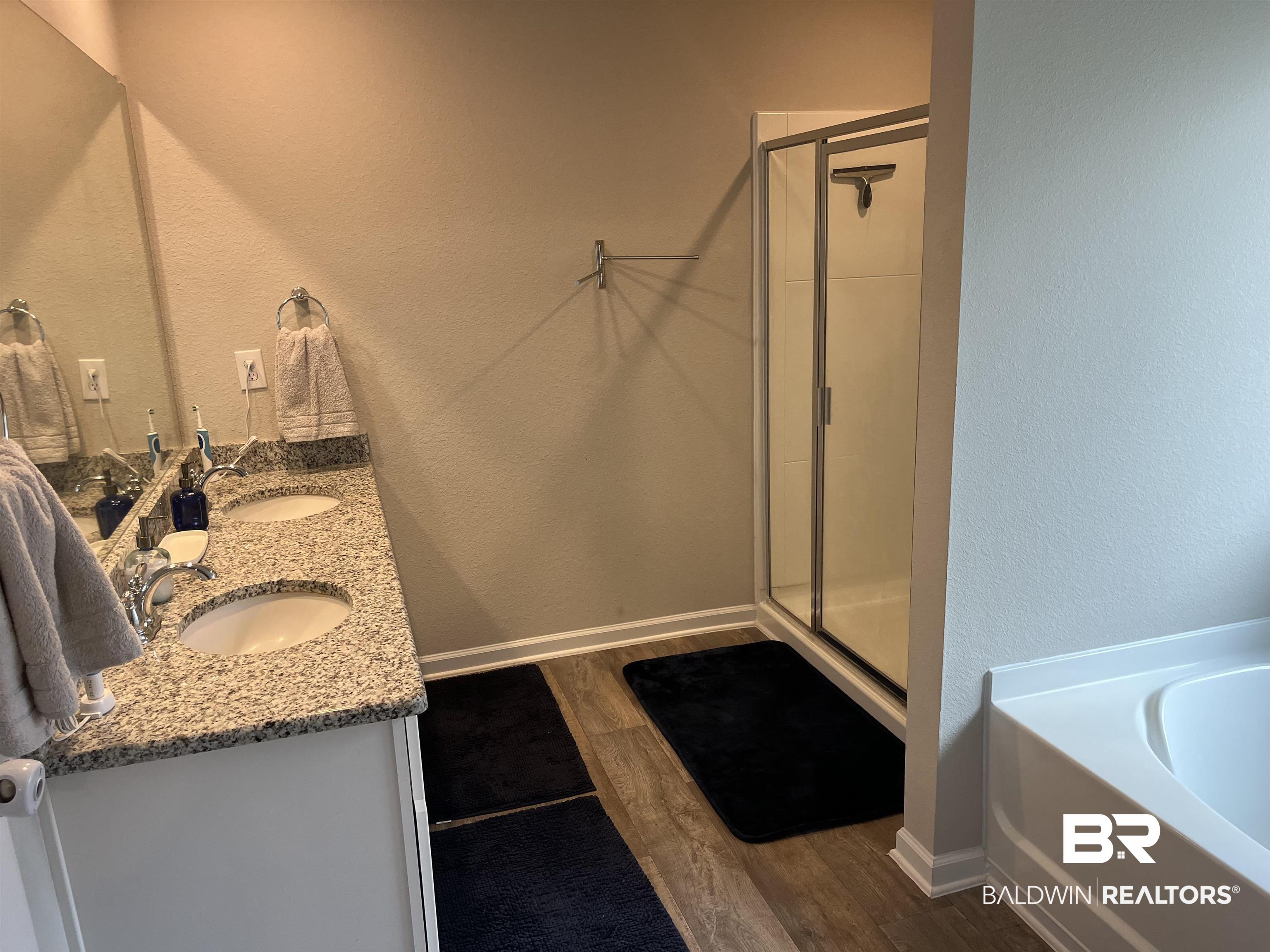 7952 Irwin Loop Daphne, AL 36526 - Photo 9 of 22 Bathroom with plus walk in shower, vanity, and hardwood / wood-style floors