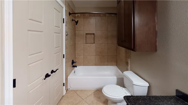 a white toilet sitting next to a bath tub