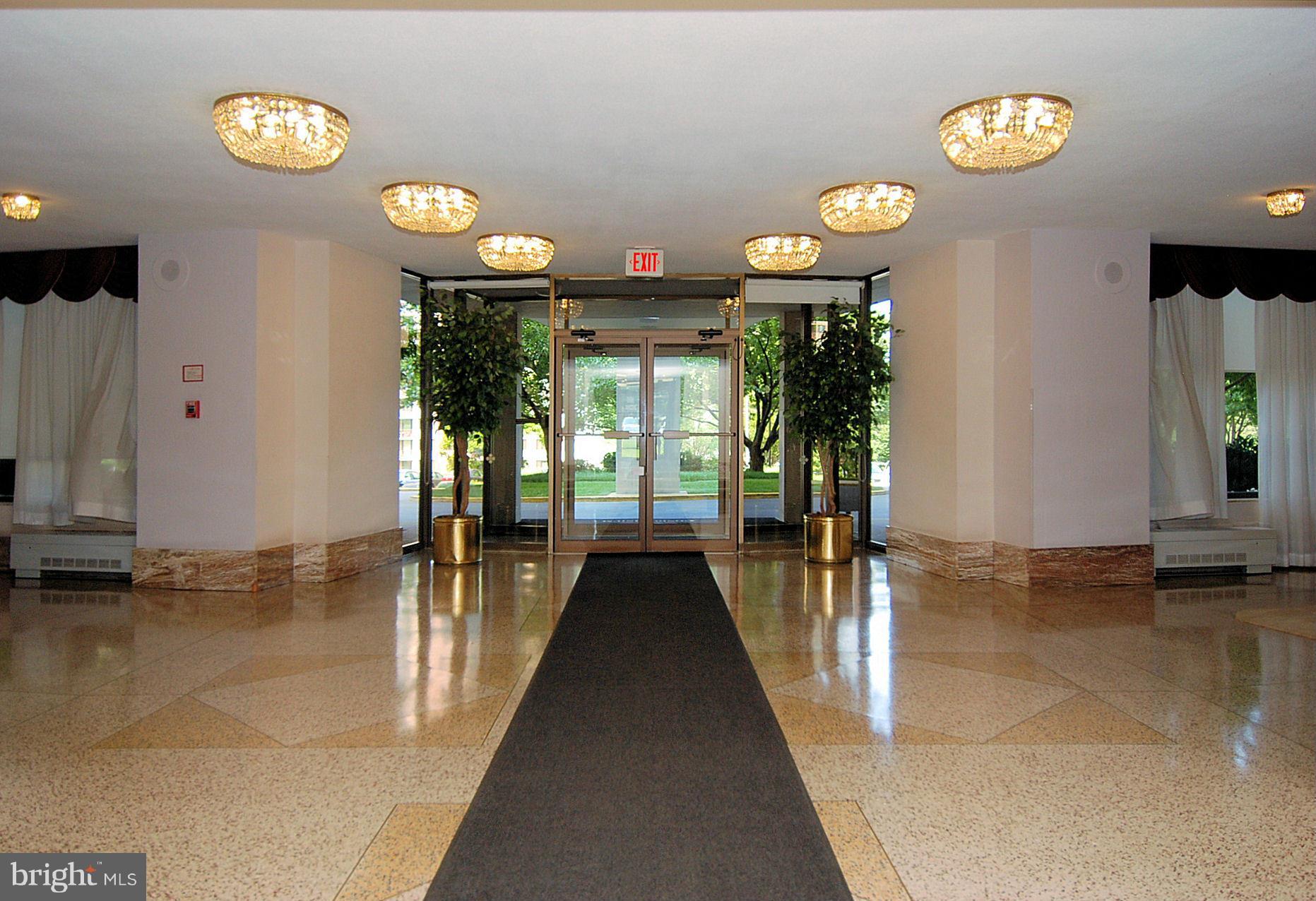 1111 University Boulevard West, Unit 907A Silver Spring, MD 20902 - Photo 8 of 15 a view of a lobby area with furniture and chandelier