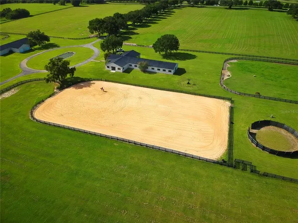 an aerial view of a golf course with a swimming pool
