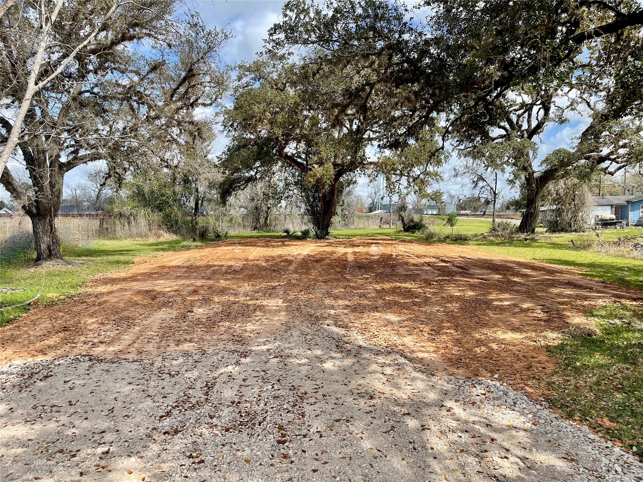 a big yard with lots of green space and trees