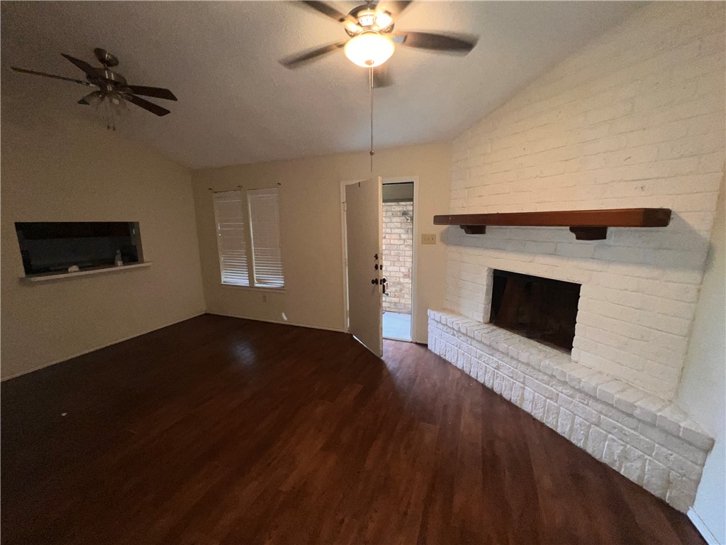 5180 Middlecoff Circle, Unit A Corpus Christi, TX 78413 - Photo 2 of 3 a view of a livingroom with a fireplace a ceiling fan and wooden floor