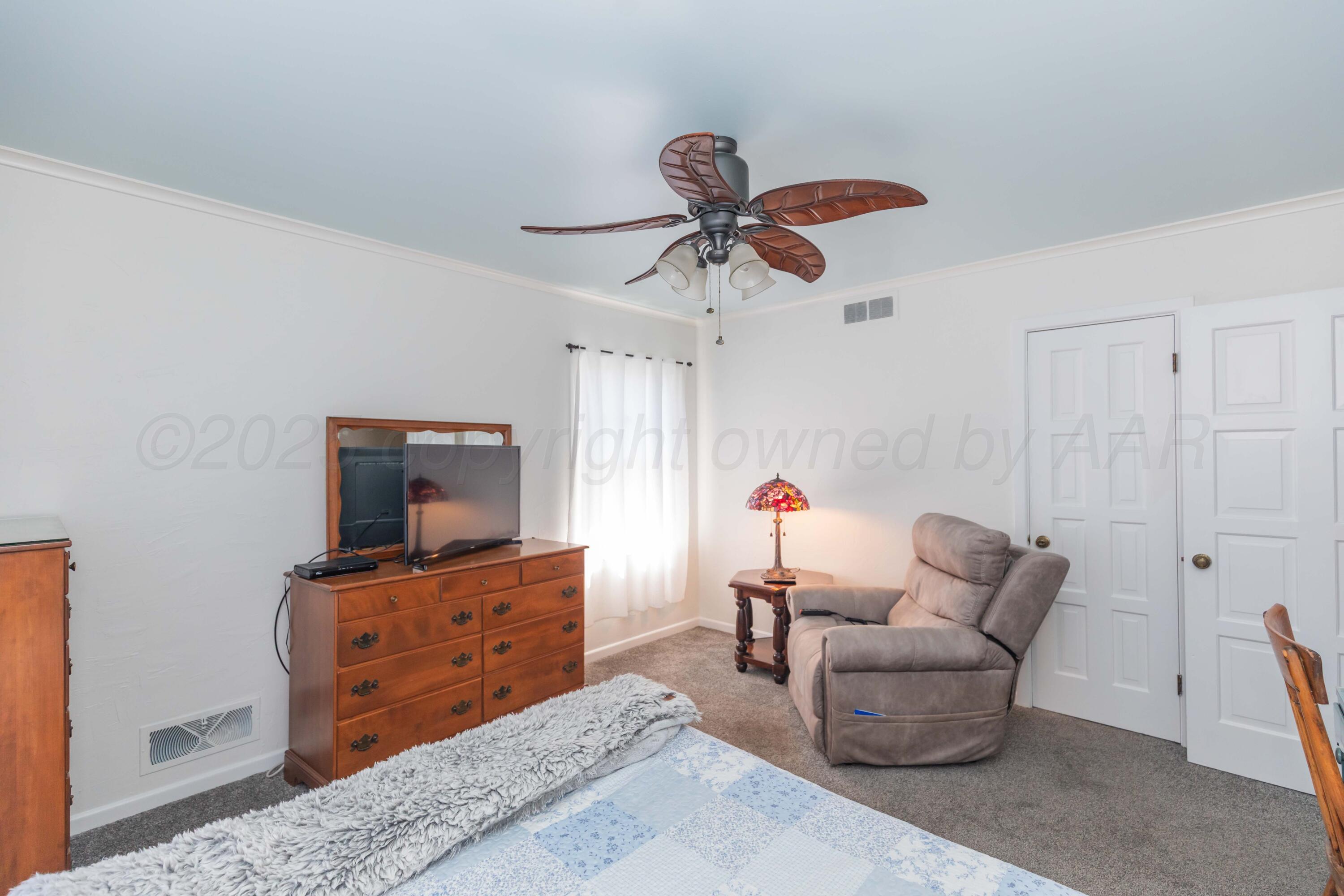 6019 Jameson Road Amarillo, TX 79106 - Photo 17 of 52 a living room with furniture and a flat screen tv