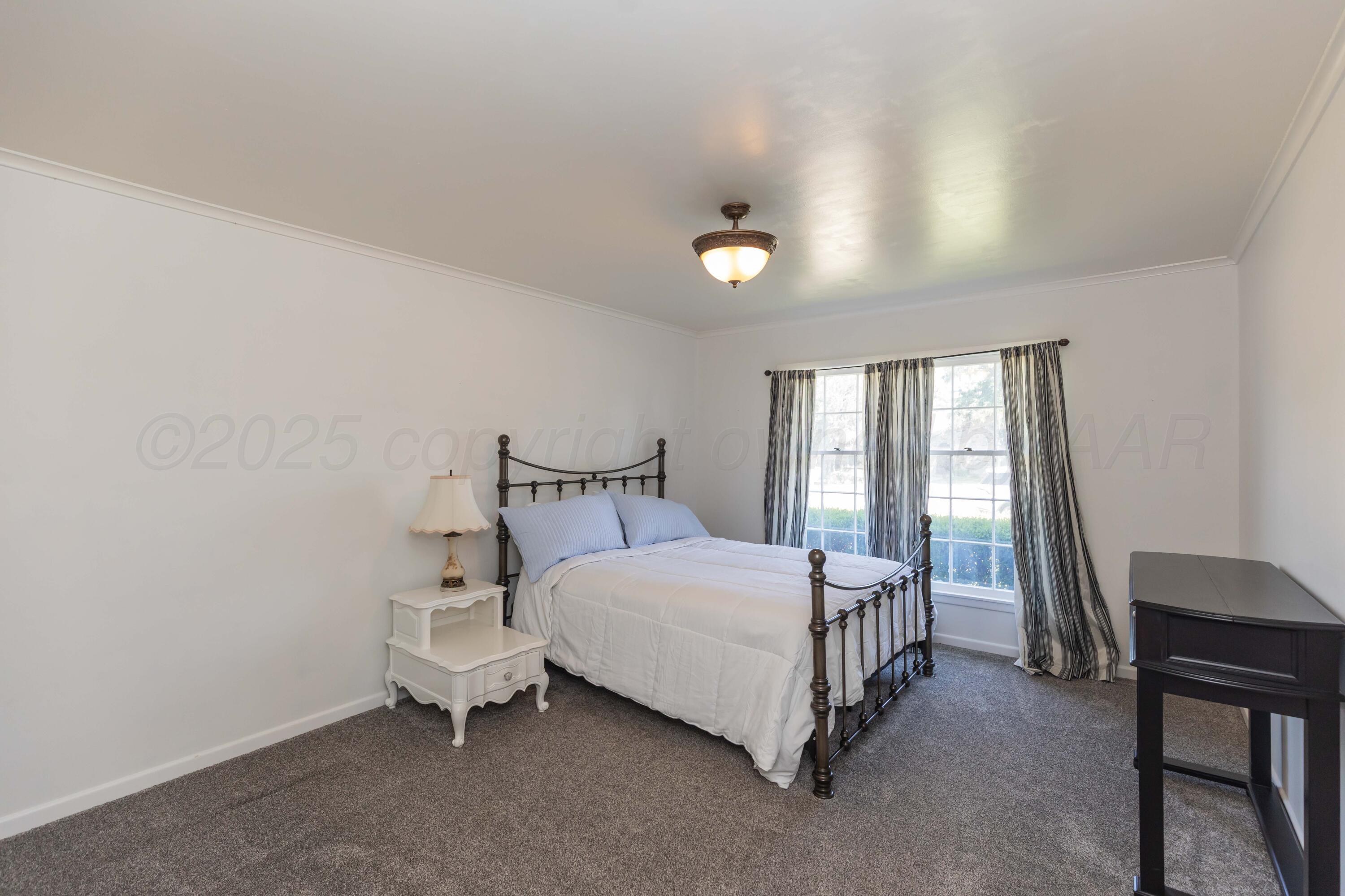6019 Jameson Road Amarillo, TX 79106 - Photo 19 of 52 a bedroom with a bed and a window