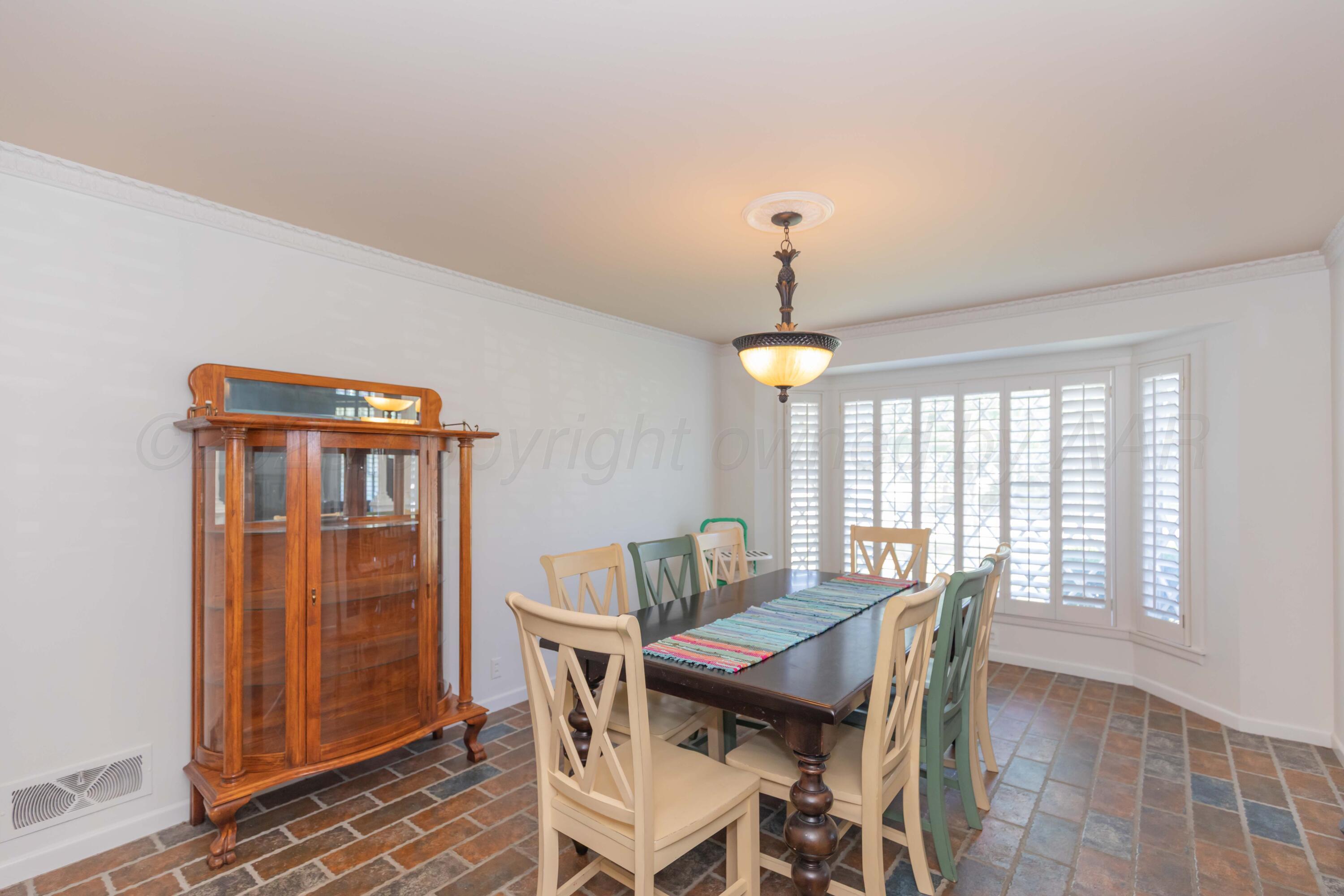 6019 Jameson Road Amarillo, TX 79106 - Photo 36 of 52 a view of a dining room with furniture window and wooden floor