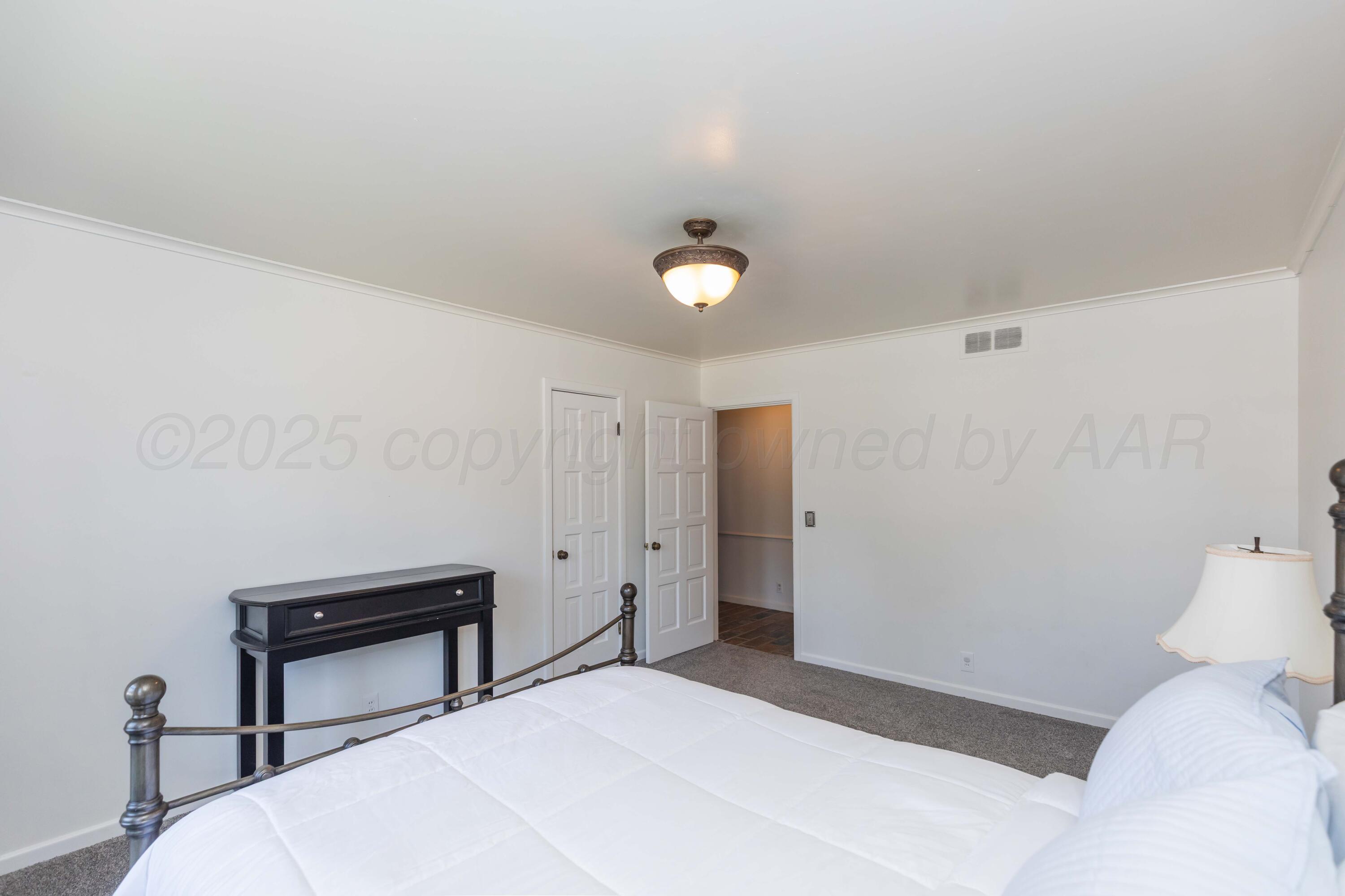 6019 Jameson Road Amarillo, TX 79106 - Photo 44 of 52 a bedroom with a bed and a desk