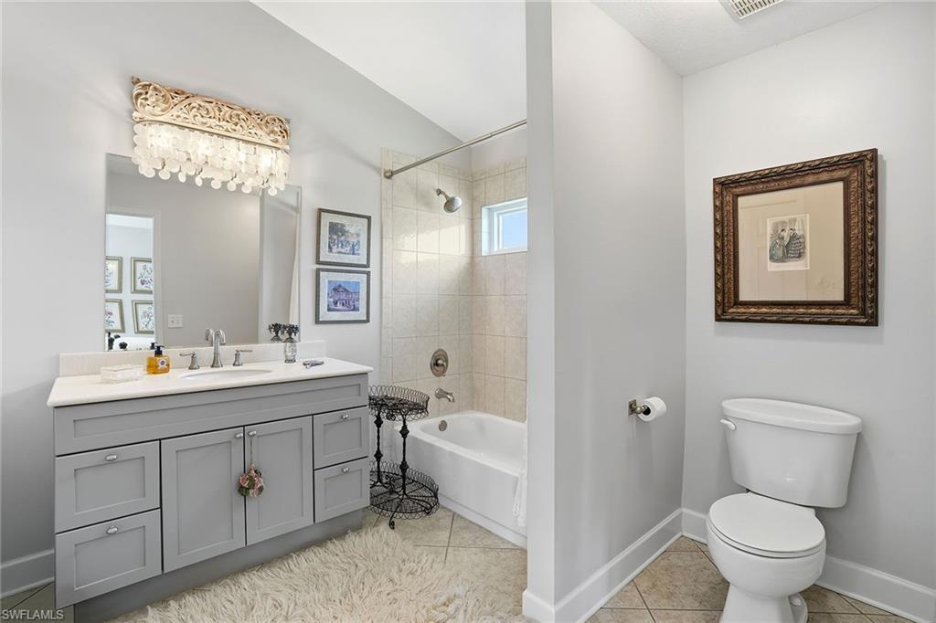 3688 Kent Drive Naples, FL 34112 - Photo 9 of 21 a bathroom with a toilet sink and mirror