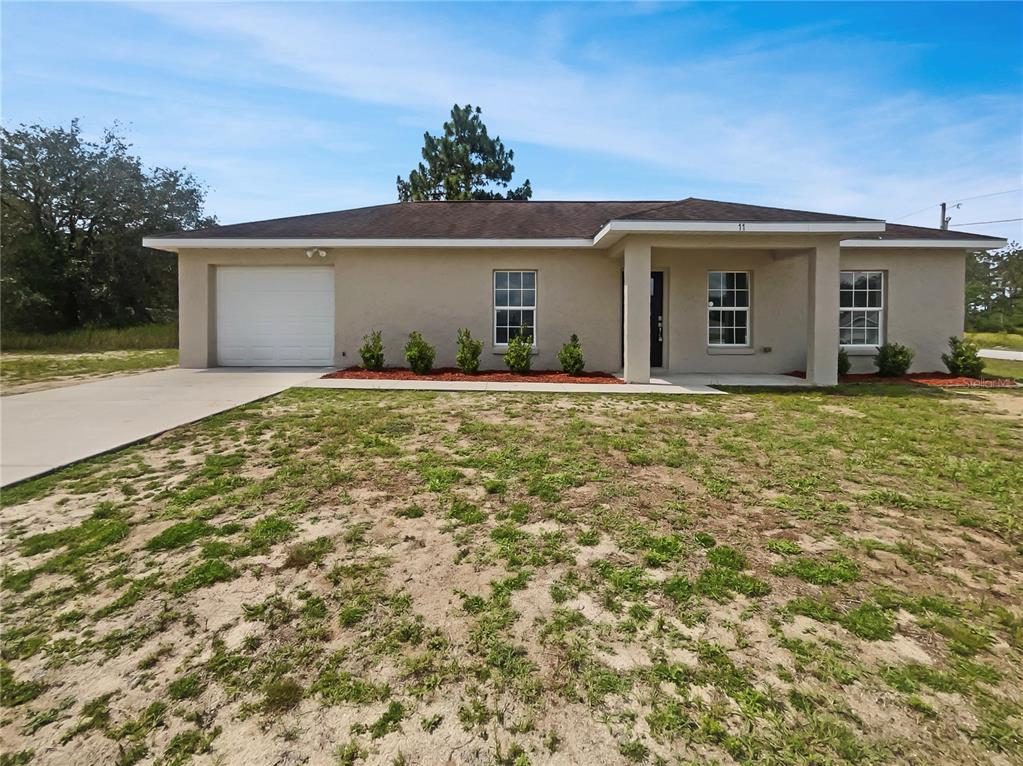 11 Ash Pass Ocala, FL 34472 - Photo 1 of 1 front view of a house with a yard