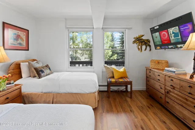 a bedroom with furniture and wooden floor