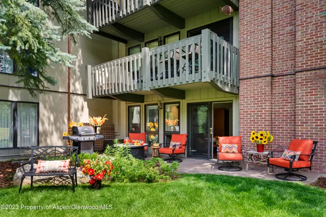a view of a chairs and table in backyard of the house