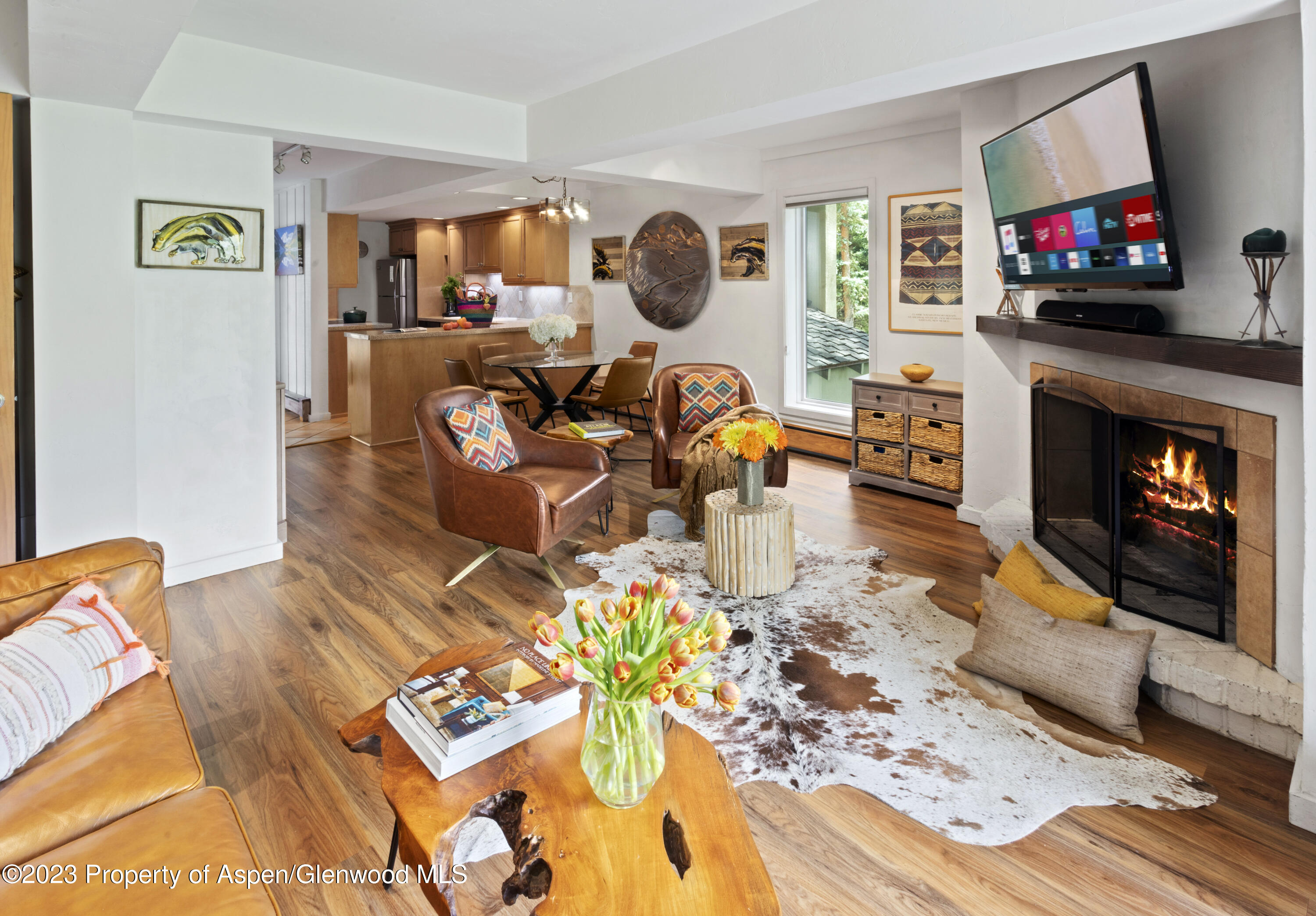 Snowmass Village Snowmass Village, CO 81615 - Photo 3 of 23 a living room with furniture a flat screen tv and a fireplace