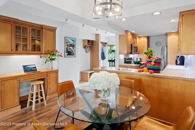 a view of a dining room with furniture a chandelier and wooden floor