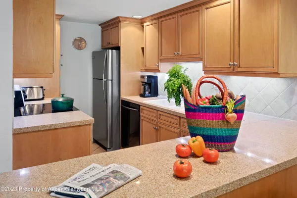 a kitchen with stainless steel appliances a refrigerator sink and cabinets