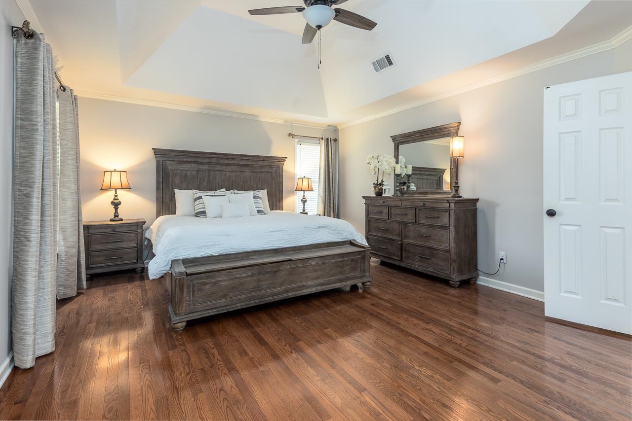905 Grapevine Drive Collierville, TN 38017 - Photo 15 of 25 a bedroom with a bed and a chandelier