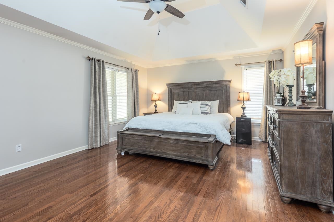 905 Grapevine Drive Collierville, TN 38017 - Photo 16 of 25 a bedroom with a bed and wooden floor