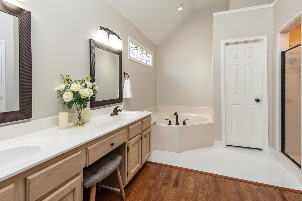 905 Grapevine Drive Collierville, TN 38017 - Photo 18 of 25 a spacious bathroom with a granite countertop sink and a mirror