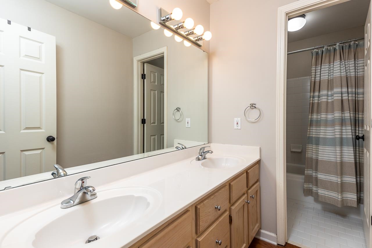 905 Grapevine Drive Collierville, TN 38017 - Photo 22 of 25 a bathroom with a sink double vanity and a mirror