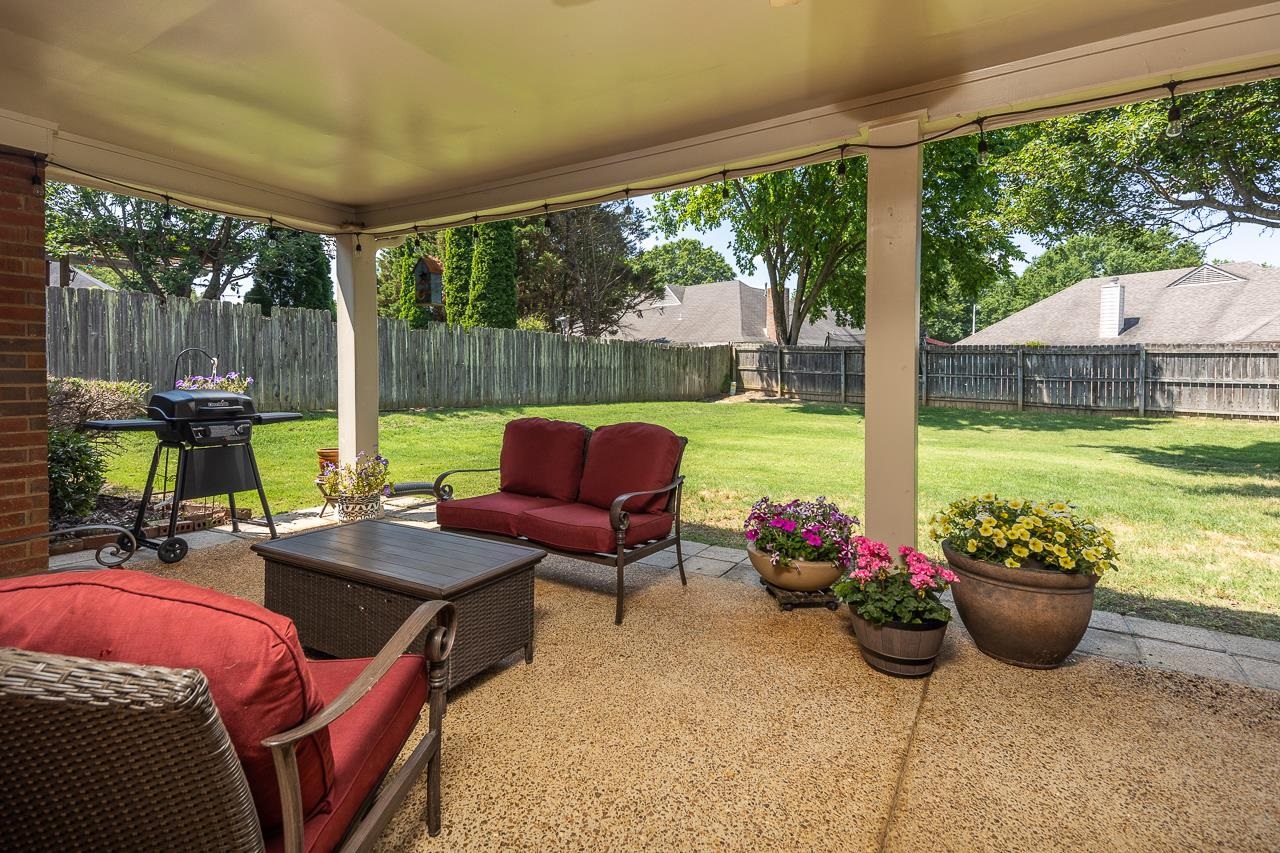 905 Grapevine Drive Collierville, TN 38017 - Photo 23 of 25 a view of a patio with lawn chairs and a potted plant