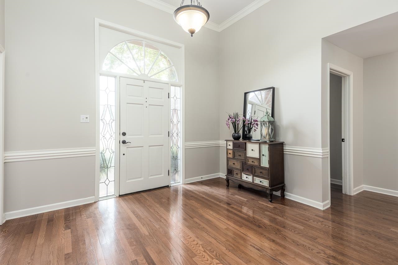905 Grapevine Drive Collierville, TN 38017 - Photo 4 of 25 an empty room with wooden floor mirror and windows