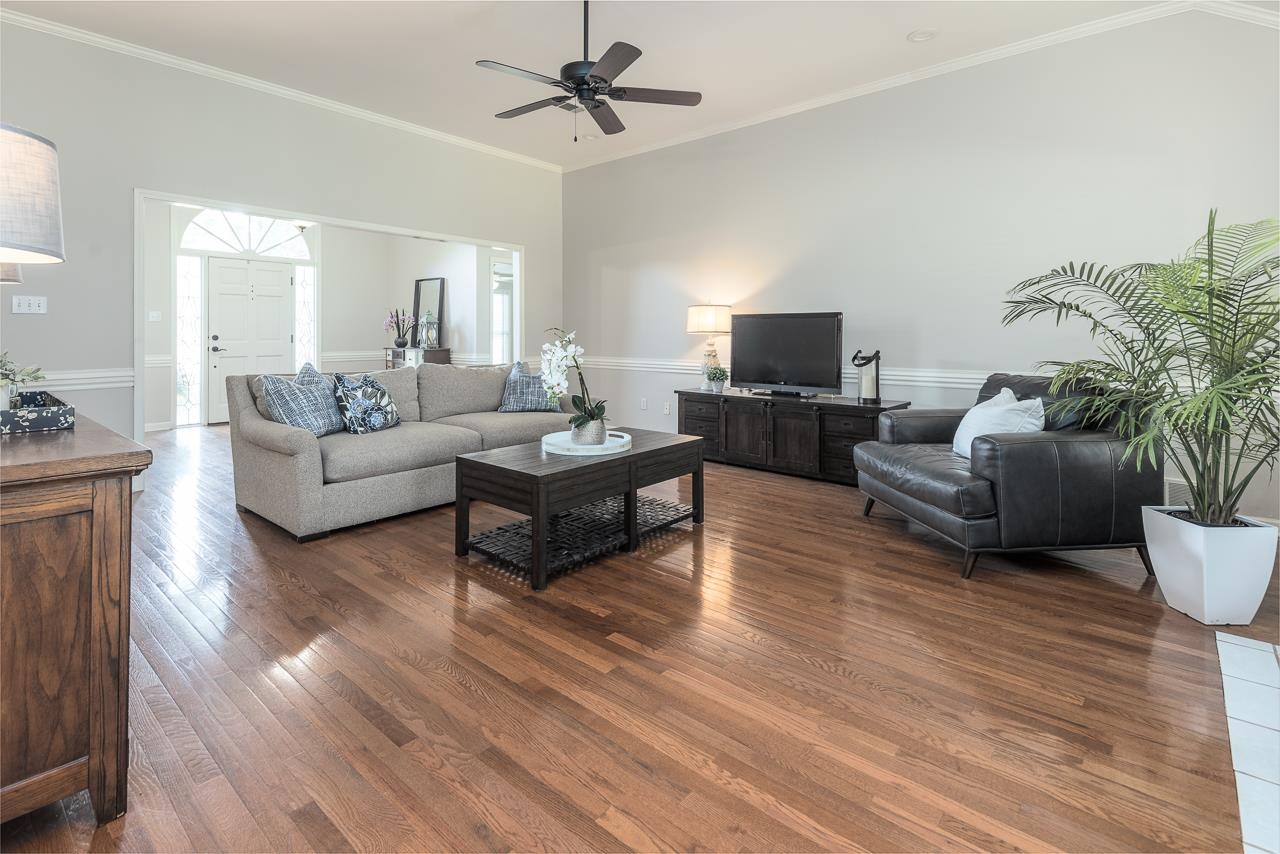 905 Grapevine Drive Collierville, TN 38017 - Photo 6 of 25 a living room with furniture flat screen tv and wooden floor