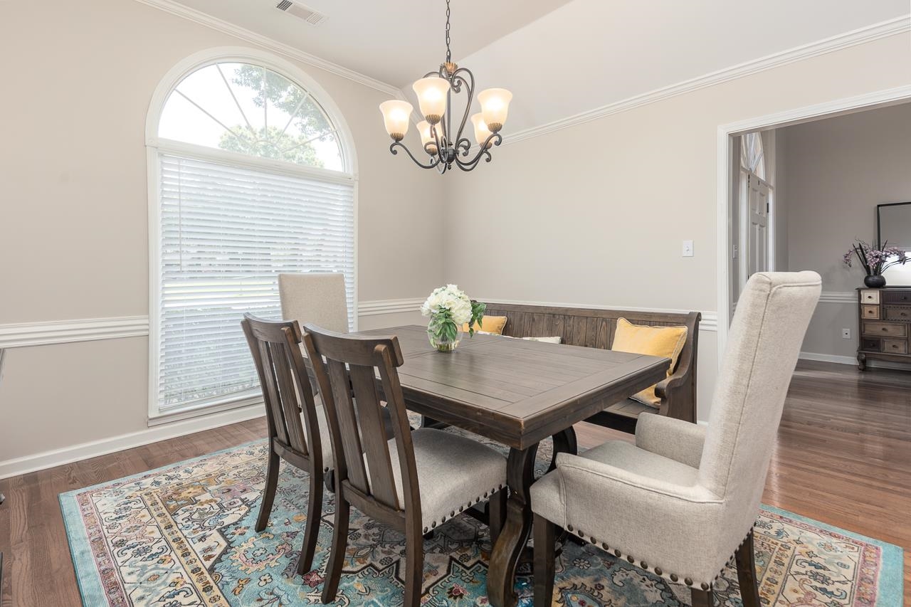 905 Grapevine Drive Collierville, TN 38017 - Photo 9 of 25 a view of a dining room with furniture a chandelier and wooden floor