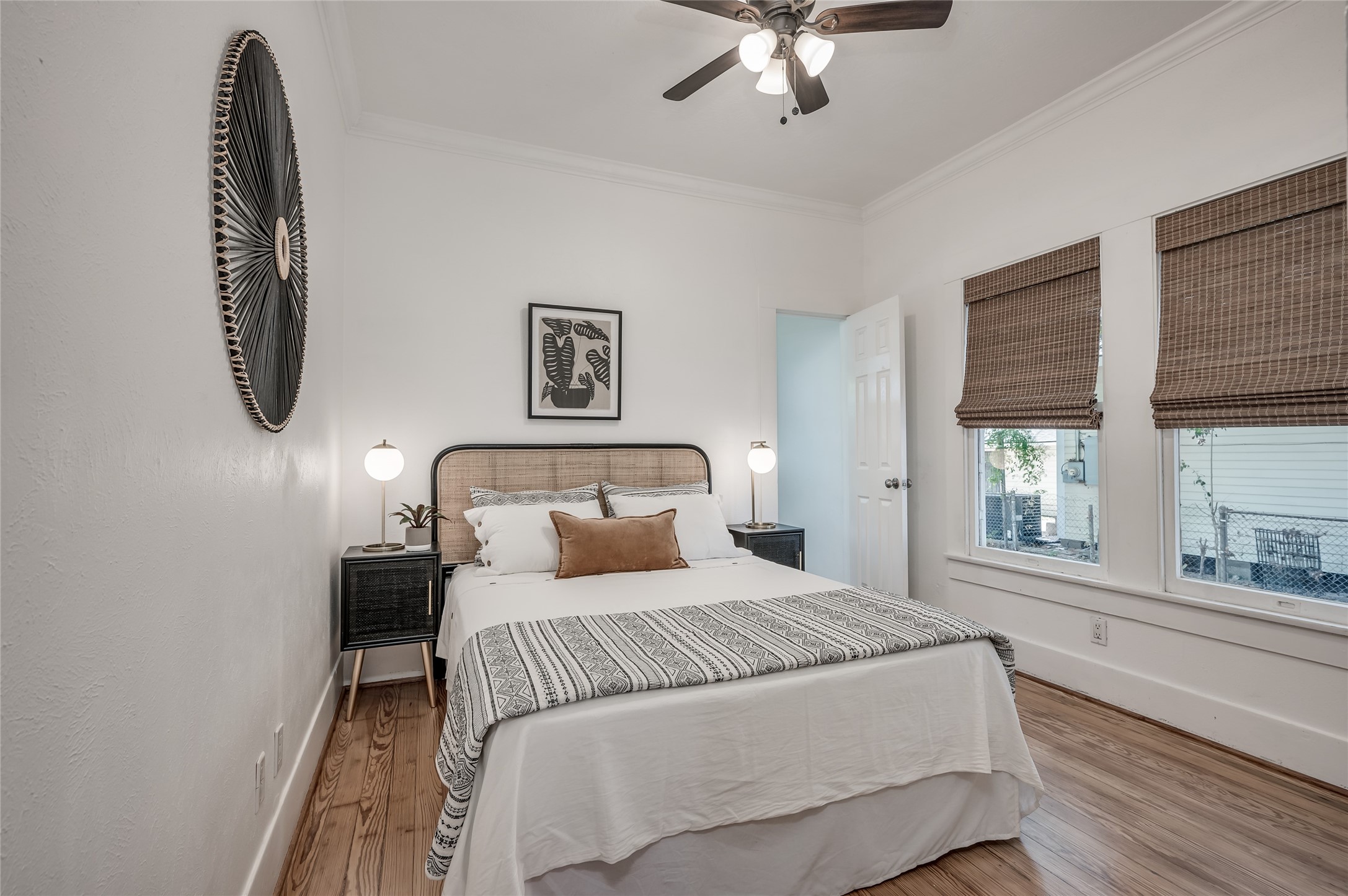 208 Archer Street Houston, TX 77009 - Photo 22 of 26 The primary bedroom is a lovely retreat with ceiling fan, high ceilings, and bamboo Roman shades.