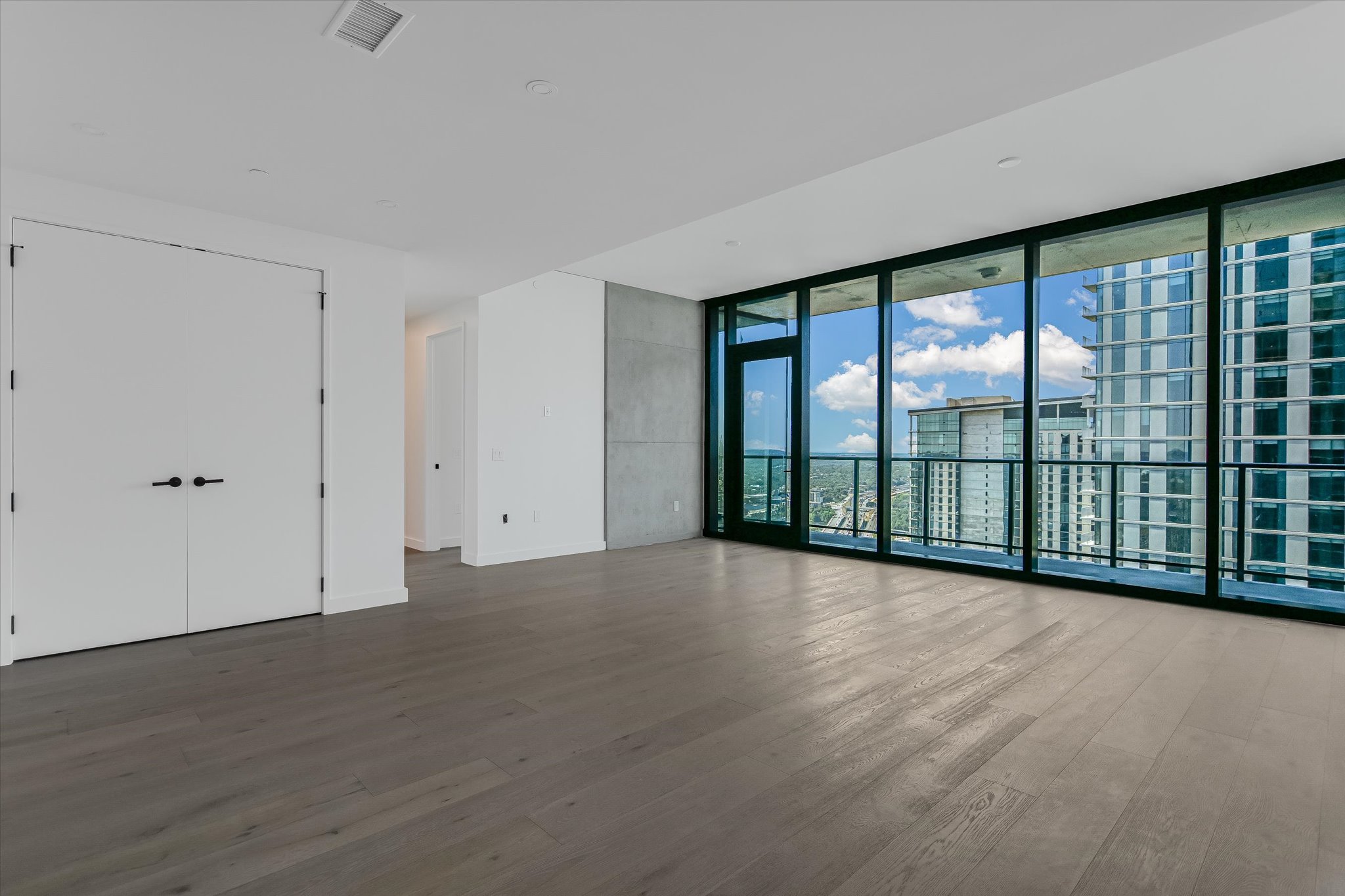 610 Davis Street, Unit 3801 Austin, TX 78701 - Photo 13 of 40 wooden floor in an empty room with a large window